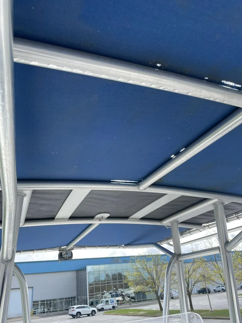 Slide: The Image of Edgewater 220CC 2000 boat canopy with blue fabric and metal frame. - 14