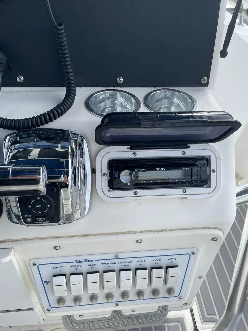 Slide: The Image of Edgewater 220CC 2000 boat console with controls and Sony stereo system. - 16