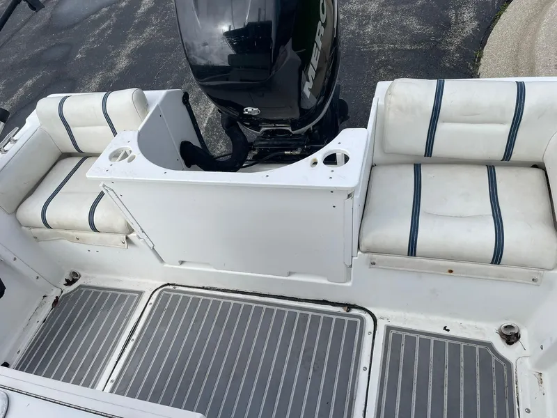 Slide: The Image of Edgewater 220CC boat interior with cushioned seating and outboard motor, 2000 model. - 18