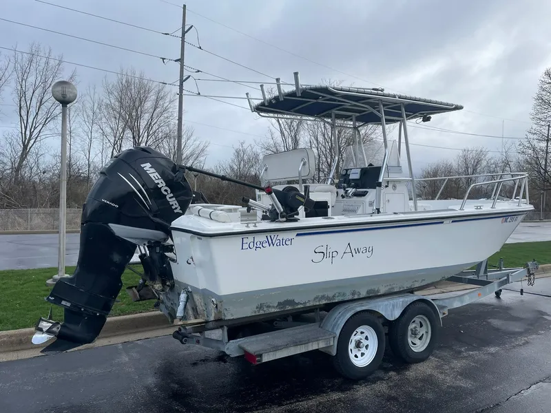 Slide: The Image of 2000 Edgewater 220CC boat on trailer with Mercury outboard motor, labeled "Slip Away." - 2