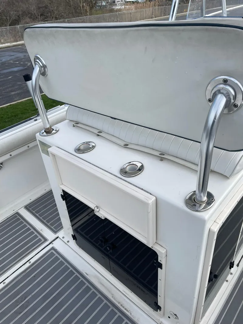 Slide: The Image of Edgewater 220CC 2000 boat console with stainless steel handles and storage compartments. - 20
