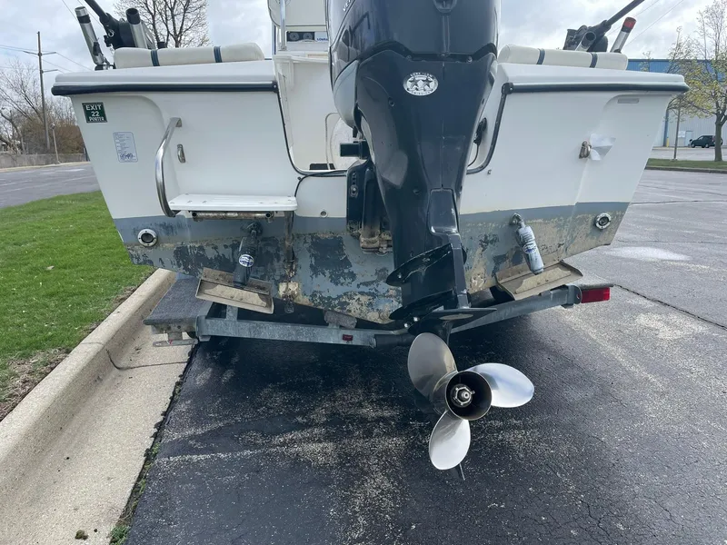 Slide: The Image of Rear view of a 2000 Edgewater 220CC boat on a trailer, showing the outboard motor. - 21