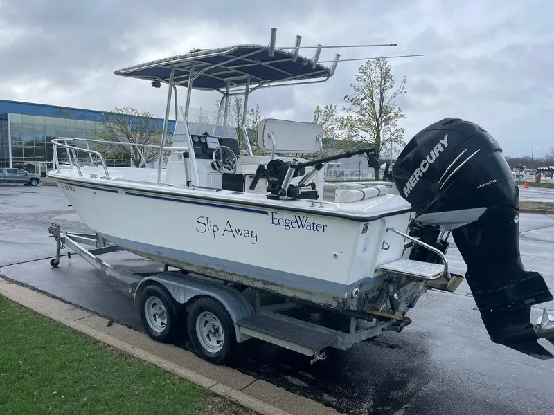 Slide: The Image of Edgewater 220CC boat on trailer, featuring Mercury outboard motor, parked outdoors. - 3