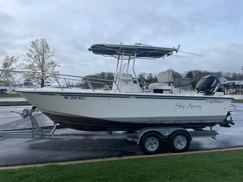 Slide: The Image of Edgewater 220CC 2000 boat on trailer, parked outdoors on a cloudy day. - 4