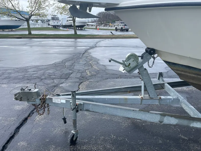 Slide: The Image of Trailer hitch of a 2000 Edgewater 220CC boat in a parking lot. - 7