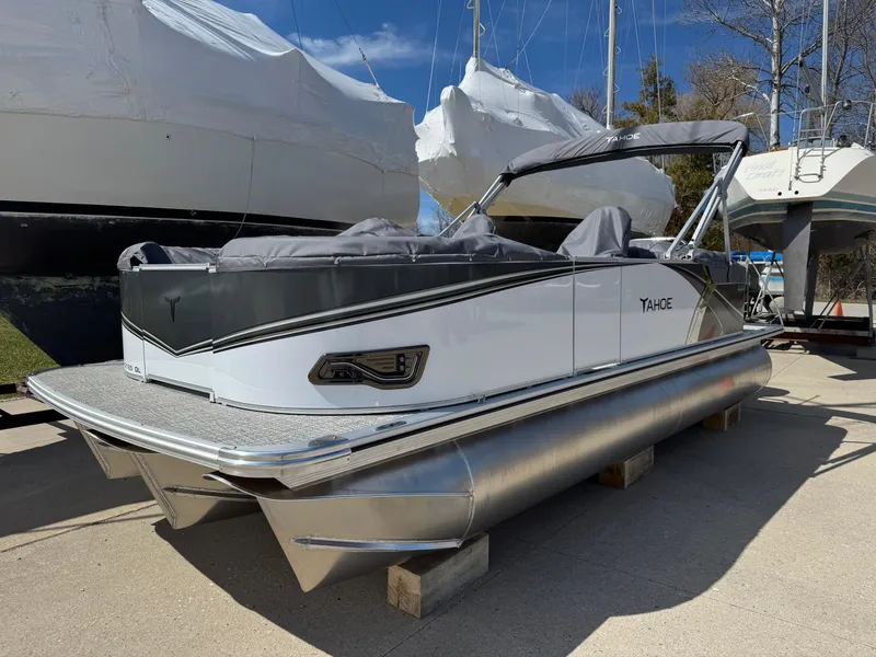 The Image of 2025 Tahoe Pontoon LTZ Quad Lounger, sleek design, docked outdoors under clear sky. - 0
