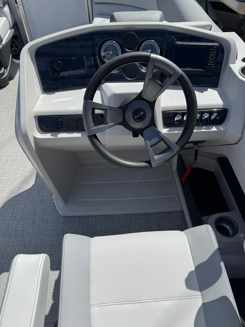 Slide: The Image of 2025 Tahoe Pontoon LTZ Quad Lounger steering console with modern controls and gauges. - 12