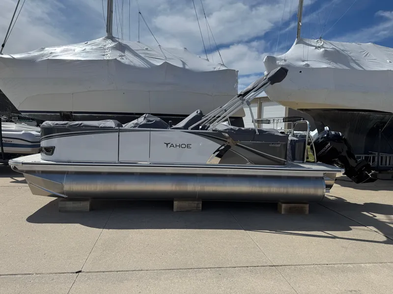 Slide: The Image of 2025 Tahoe Pontoon LTZ Quad Lounger on display, docked outdoors under a clear sky. - 2