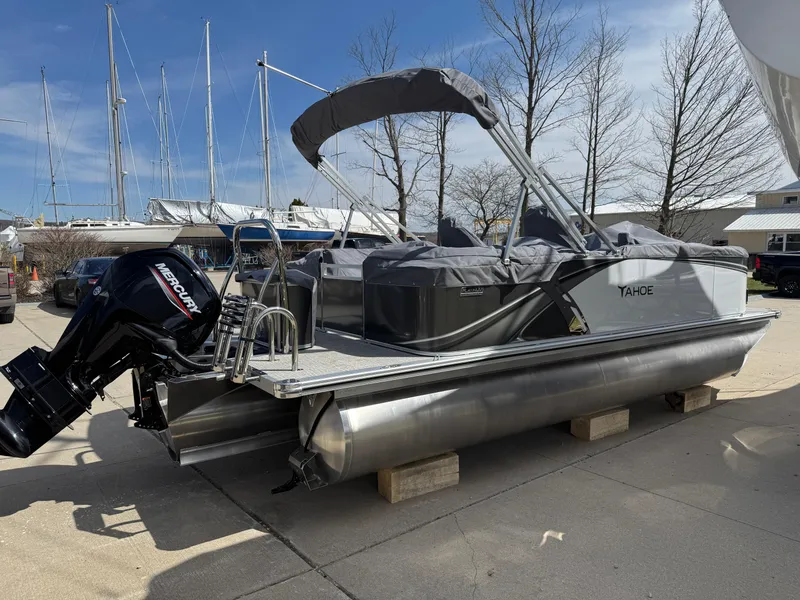 Slide: The Image of 2025 Tahoe Pontoon LTZ Quad Lounger with canopy and outboard motor on display. - 5