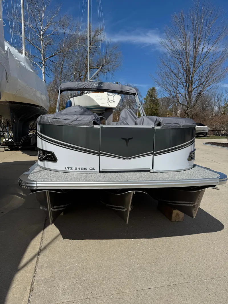 Slide: The Image of 2025 Tahoe Pontoon LTZ Quad Lounger on a sunny day, docked and covered. - 6