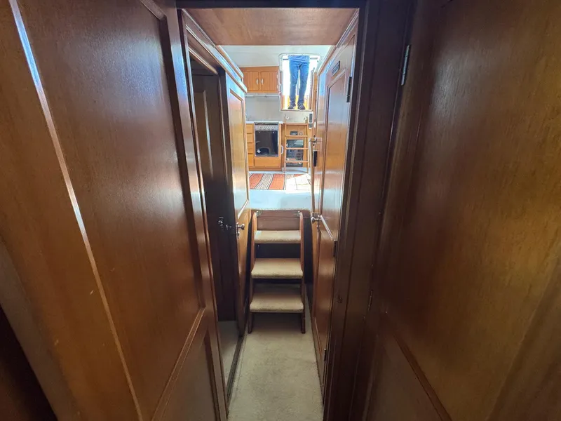 Slide: The Image of 1968 Hatteras 38 Double Cabin interior hallway with wooden paneling and stairs. - 11