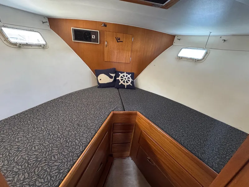 Slide: The Image of 1968 Hatteras 38 Double Cabin interior with cozy V-berth and nautical-themed decor. - 12