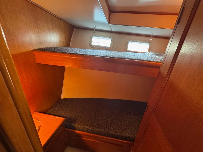Slide: The Image of 1968 Hatteras 38 Double Cabin interior with wooden bunk beds and small windows. - 14