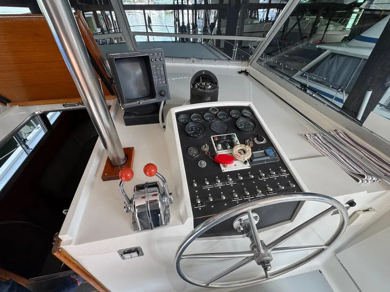 Slide: The Image of Helm of 1968 Hatteras 38 Double Cabin with steering wheel and control panel. - 19