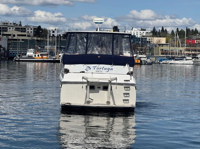 Slide: The Image of 1968 Hatteras 38 Double Cabin boat on calm water, marina background. - 22