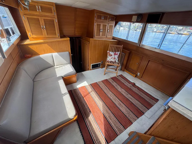 Slide: The Image of Interior of 1968 Hatteras 38 Double Cabin with sofa, chair, and striped rug. - 5