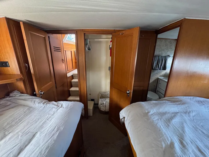 Slide: The Image of 1968 Hatteras 38 Double Cabin interior with twin beds and wooden cabinetry. - 8