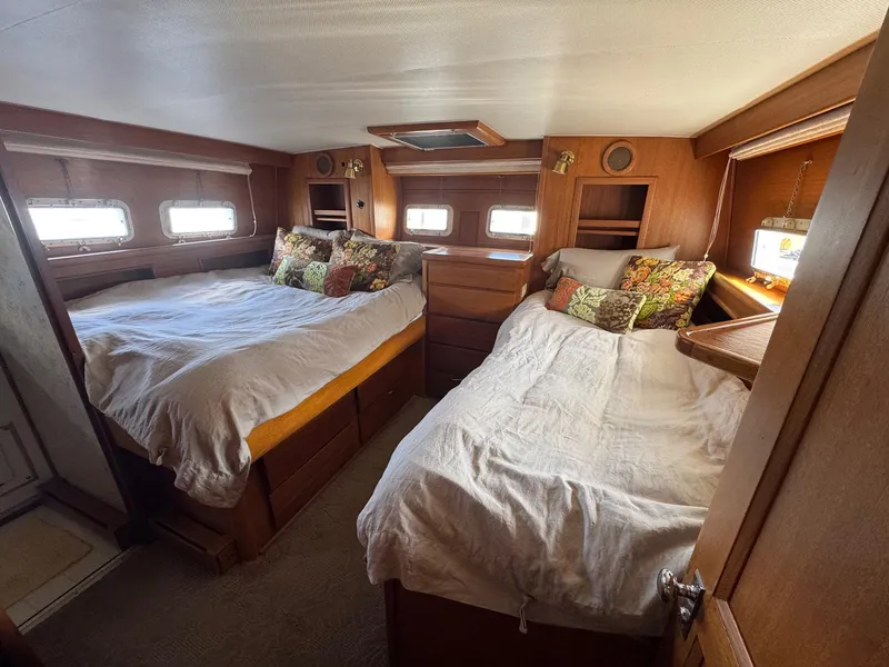 Slide: The Image of 1968 Hatteras 38 Double Cabin interior with two cozy beds and wooden furnishings. - 9