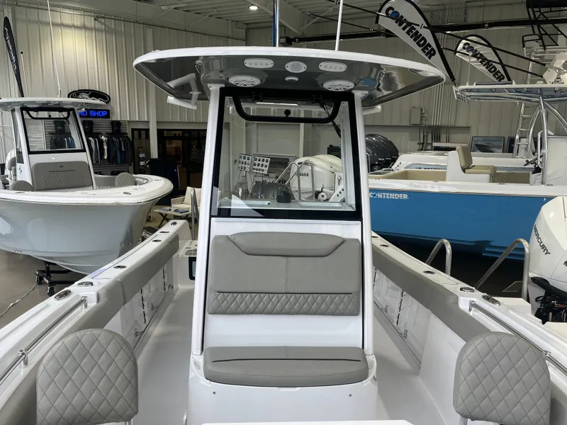 Slide: The Image of 2025 Sportsman Heritage 231 Center Console boat in showroom, featuring modern design and seating. - 10