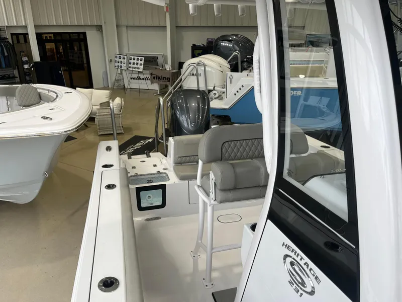 Slide: The Image of 2025 Sportsman Heritage 231 Center Console boat interior in showroom setting. - 12