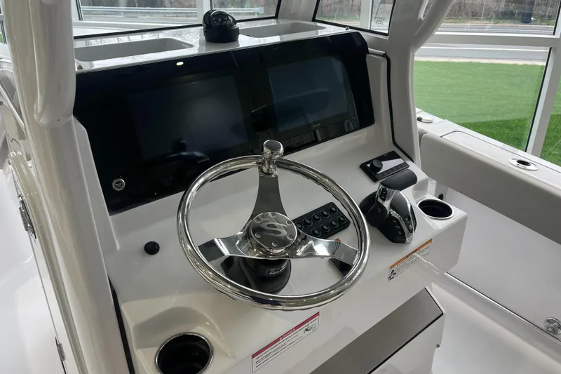 Slide: The Image of 2025 Sportsman Heritage 231 Center Console dashboard with steering wheel and controls. - 15