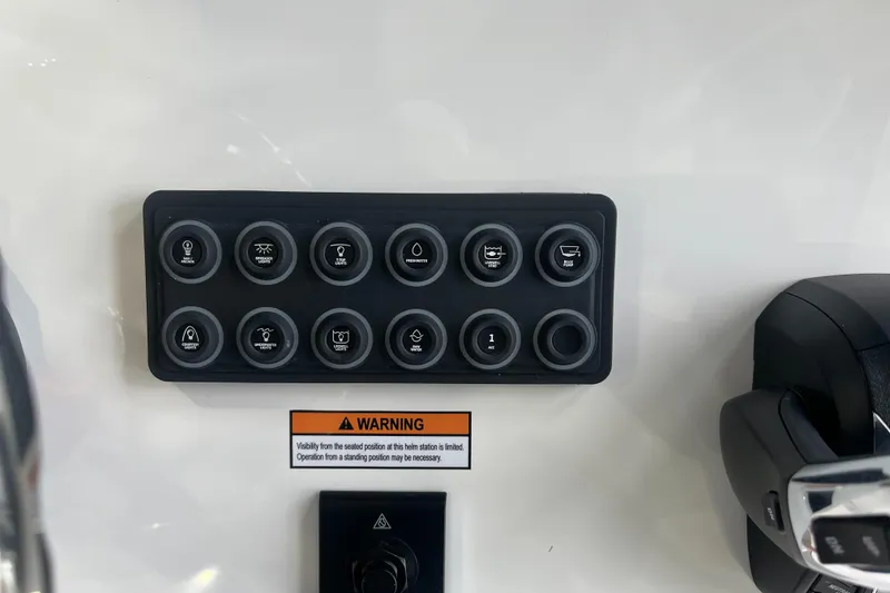 Slide: The Image of Control panel of 2025 Sportsman Heritage 231 Center Console boat with warning label. - 18