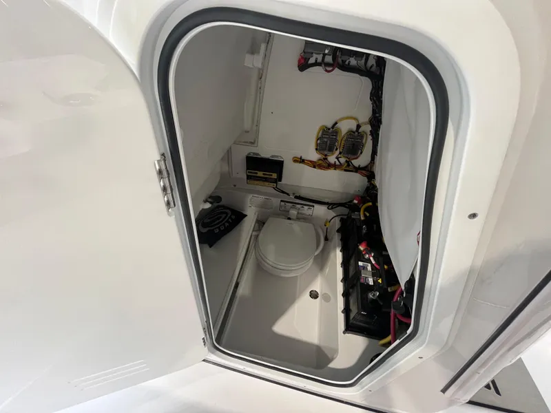 Slide: The Image of 2025 Sportsman Heritage 231 Center Console interior with marine toilet and electrical components. - 19