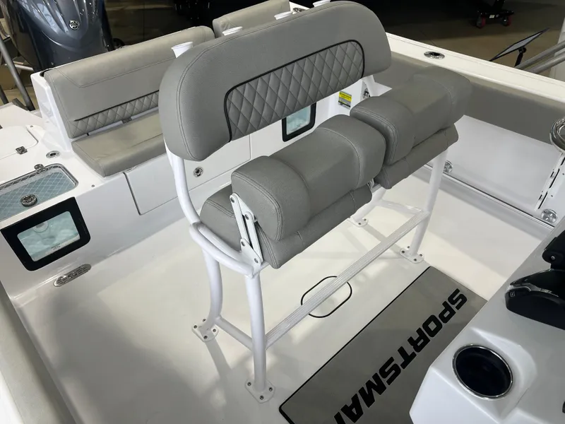 Slide: The Image of 2025 Sportsman Heritage 231 Center Console boat interior with cushioned seating and console. - 2