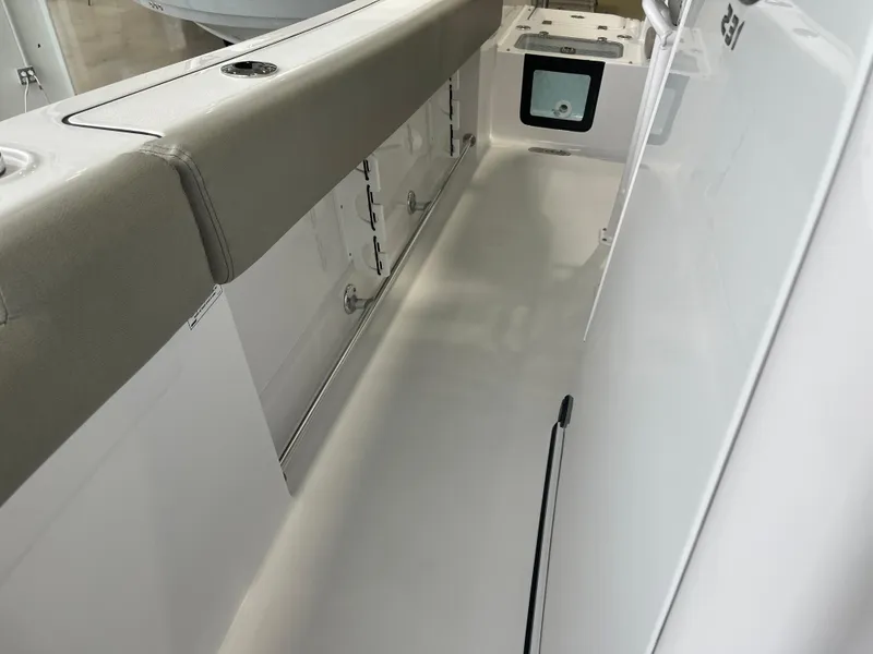 Slide: The Image of 2025 Sportsman Heritage 231 Center Console boat interior with storage compartments and seating. - 20