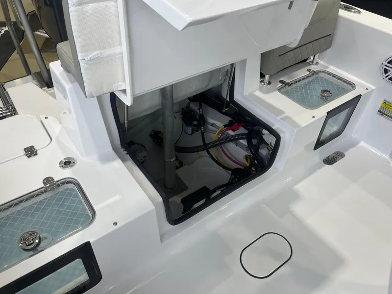 Slide: The Image of 2025 Sportsman Heritage 231 Center Console boat interior with open storage compartments. - 6