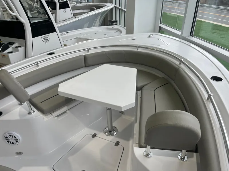 Slide: The Image of 2025 Sportsman Heritage 231 Center Console boat interior with seating and table. - 8