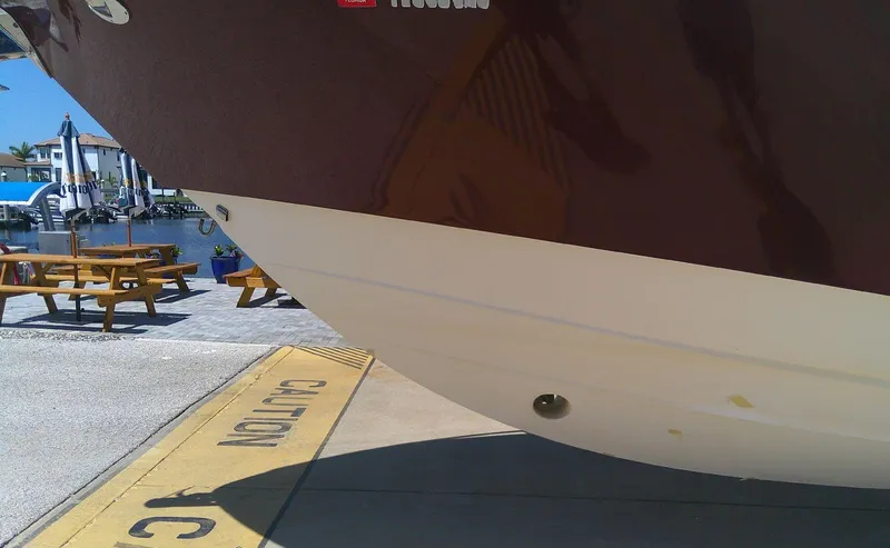 Slide: The Image of 2009 Everglades 350LX boat docked near picnic tables and waterfront. - 11