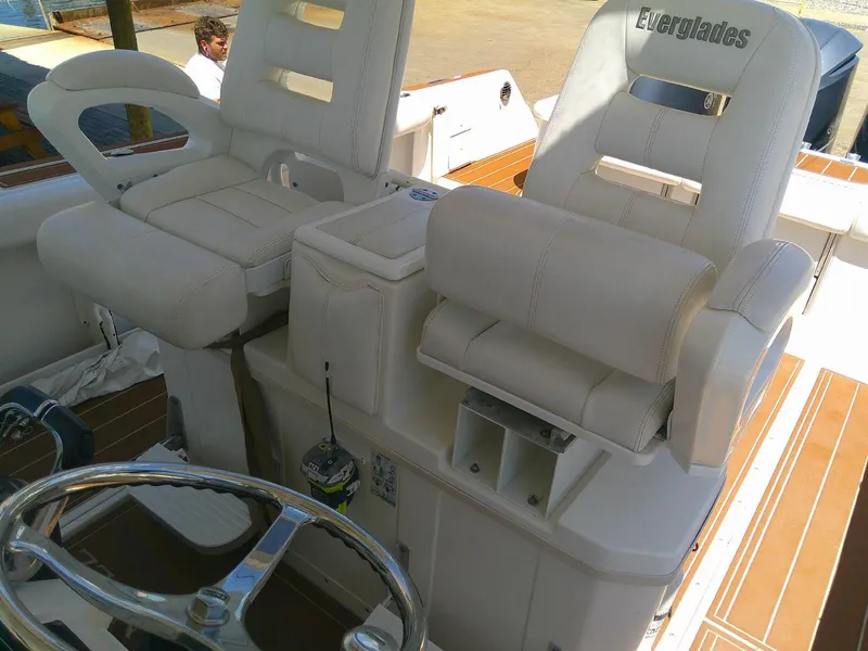 Slide: The Image of 2009 Everglades 350LX boat interior with white seating and steering wheel. - 15