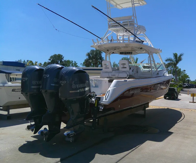 Slide: The Image of 2009 Everglades 350LX boat with triple Yamaha outboard engines on a sunny day. - 2