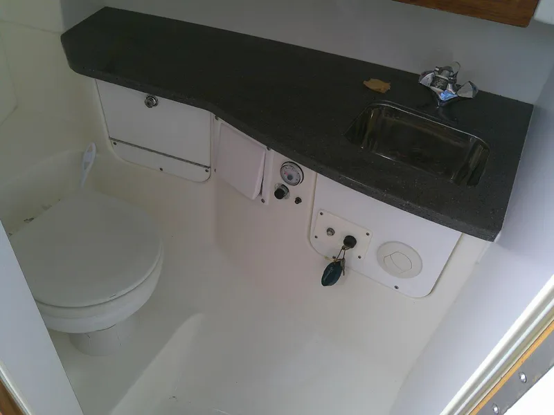 Slide: The Image of Interior of 2009 Everglades 350LX boat bathroom with sink and toilet. - 21