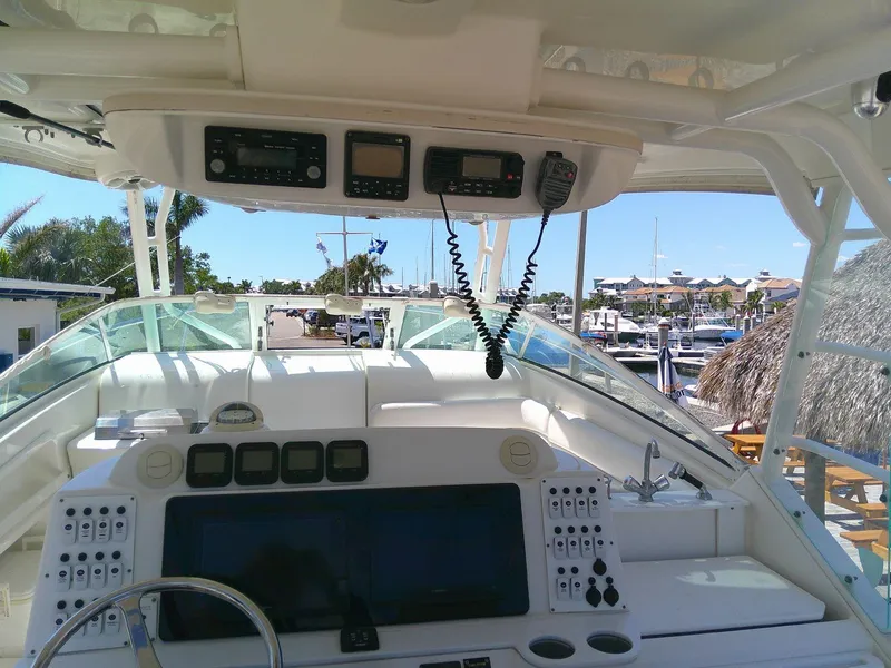 Slide: The Image of Cockpit view of 2009 Everglades 350LX boat with navigation equipment and marina background. - 26