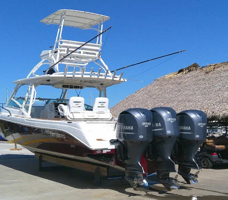 Slide: The Image of 2009 Everglades 350LX boat with triple Yamaha 350 engines, docked under clear blue sky. - 3