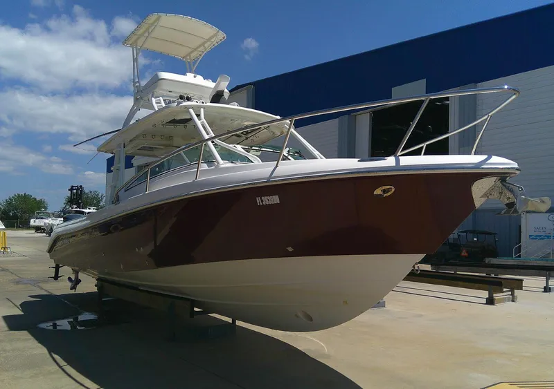 Slide: The Image of 2009 Everglades 350LX boat docked outdoors under clear blue sky. - 4