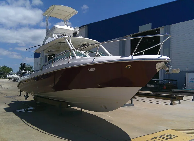 Slide: The Image of 2009 Everglades 350LX boat docked outside a blue and white building. - 7