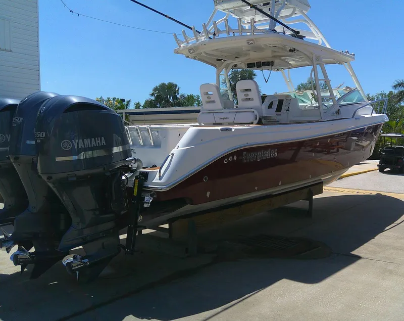 Slide: The Image of 2009 Everglades 350LX boat with Yamaha engines, docked under clear blue sky. - 9