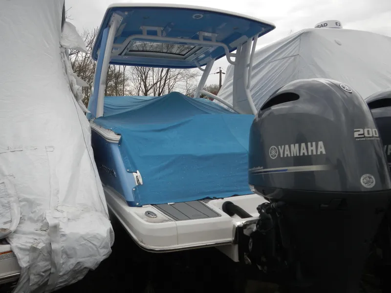 Slide: The Image of 2022 Chaparral 280 OSX boat with Yamaha 200 engine, covered and stored outdoors. - 1