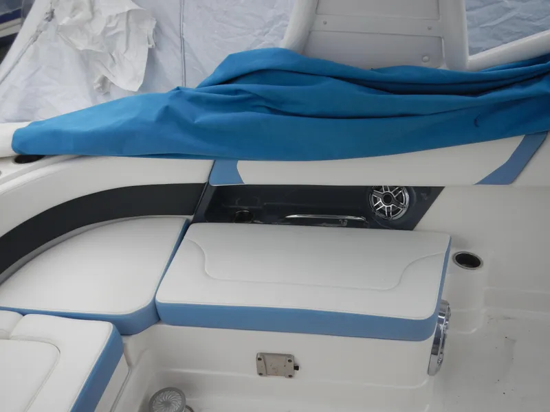 Slide: The Image of 2022 Chaparral 280 OSX boat interior with blue and white seating and speaker detail. - 11