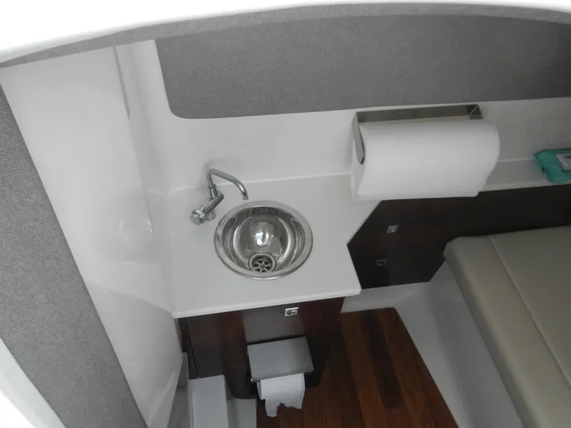 Slide: The Image of 2022 Chaparral 280 OSX boat interior with sink and paper towel holder. - 16