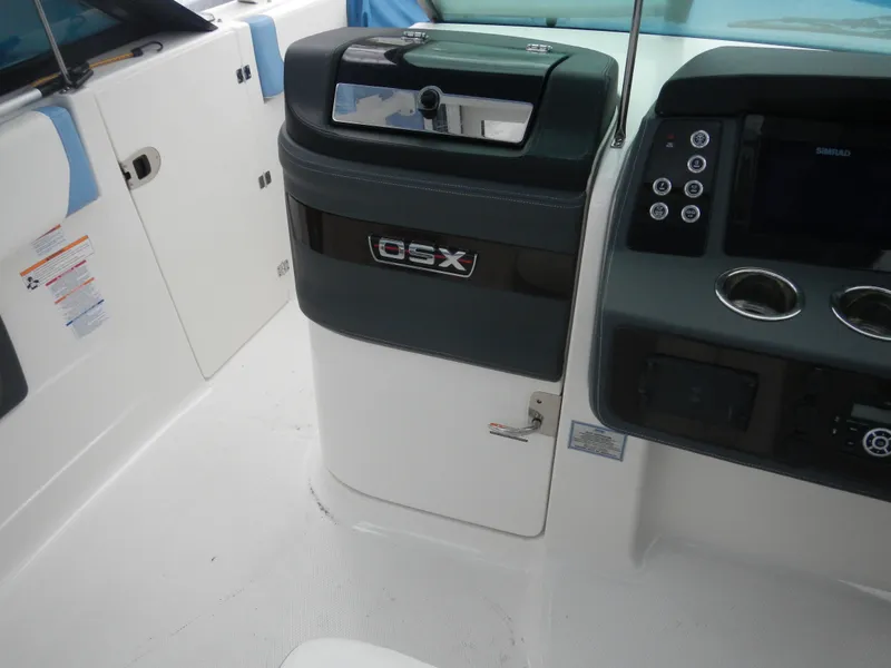 Slide: The Image of 2022 Chaparral 280 OSX boat interior with control panel and storage compartment. - 19