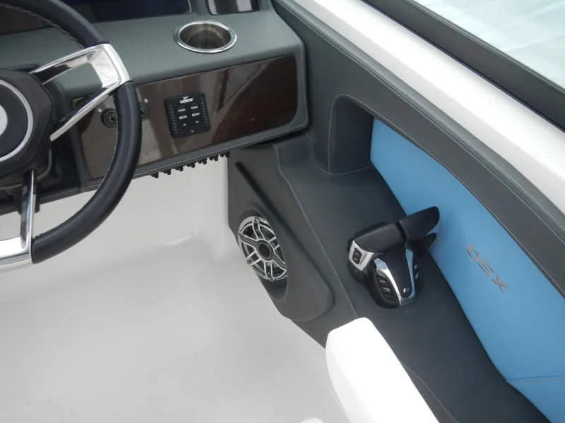 Slide: The Image of 2022 Chaparral 280 OSX boat interior with steering wheel, speaker, and control panel. - 20