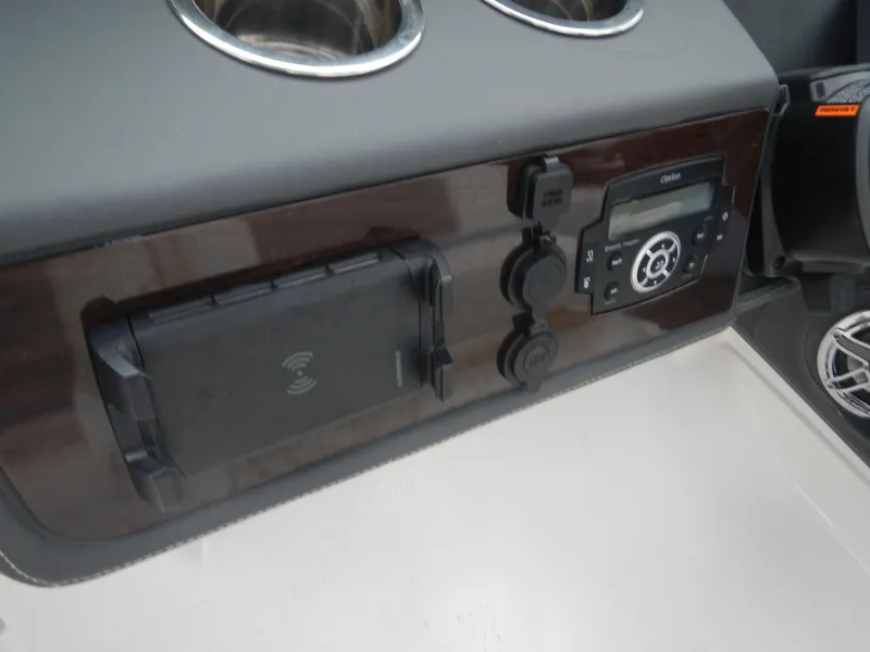 Slide: The Image of Control panel of 2022 Chaparral 280 OSX boat with cup holders and electronic devices. - 21