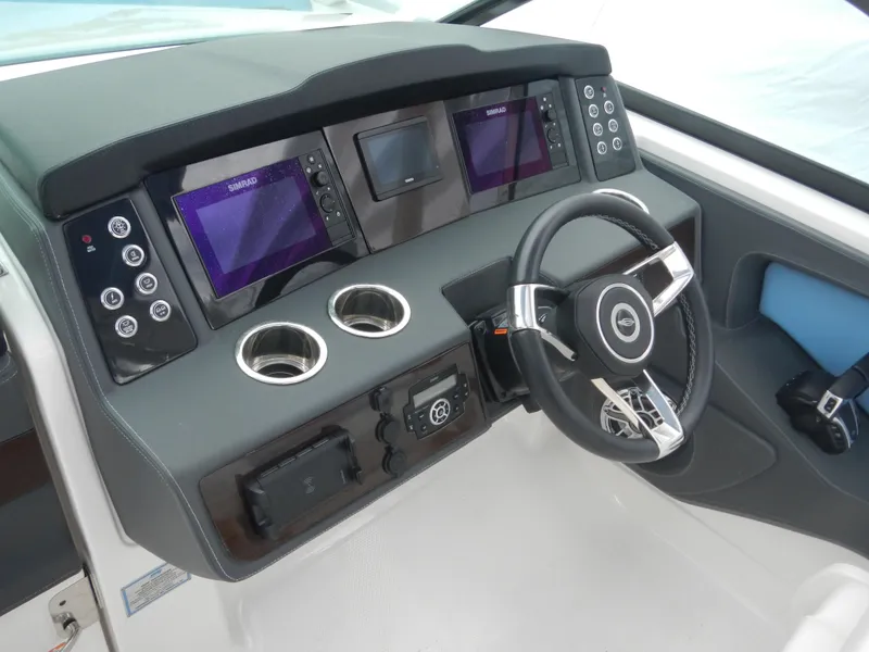 Slide: The Image of 2022 Chaparral 280 OSX helm with modern controls and dual displays. - 22