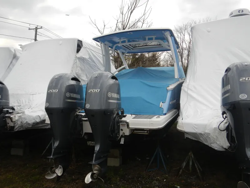 Slide: The Image of 2022 Chaparral 280 OSX boat with twin Yamaha 200 engines, covered and stored outdoors. - 3