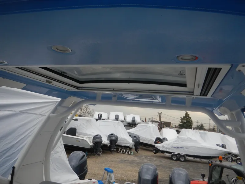 Slide: The Image of 2022 Chaparral 280 OSX boat interior with covered boats in the background. - 5