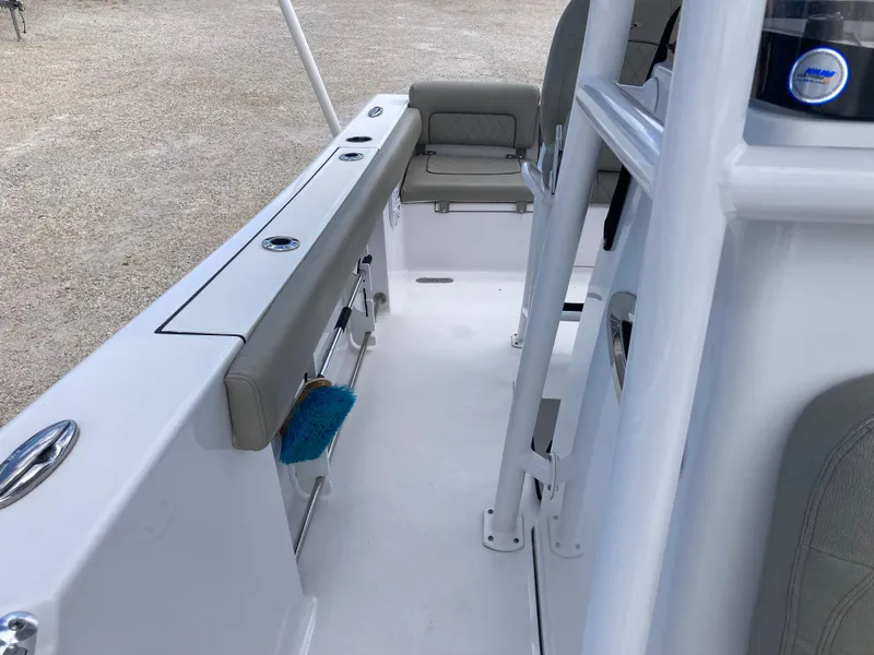 Slide: The Image of 2022 Sportsman 241 Heritage boat interior with seating and storage compartments. - 13